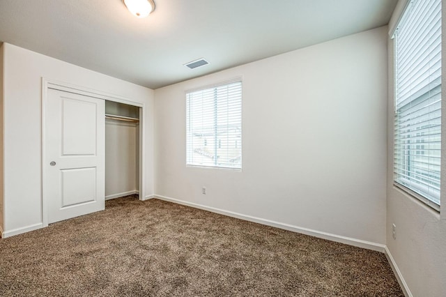 unfurnished bedroom with carpet floors and a closet