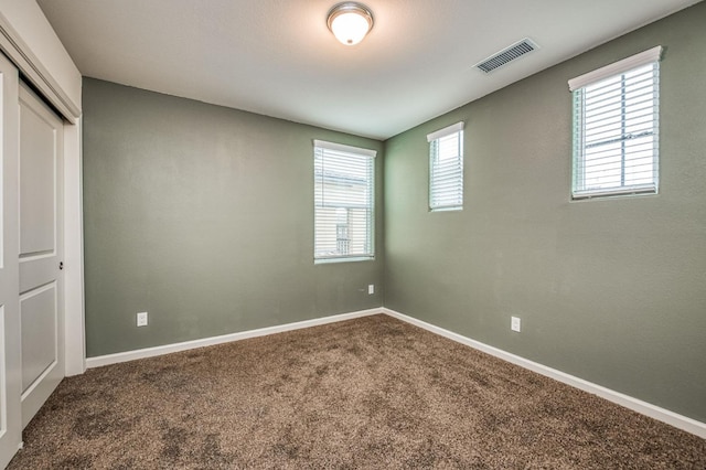 unfurnished bedroom with carpet flooring and a closet