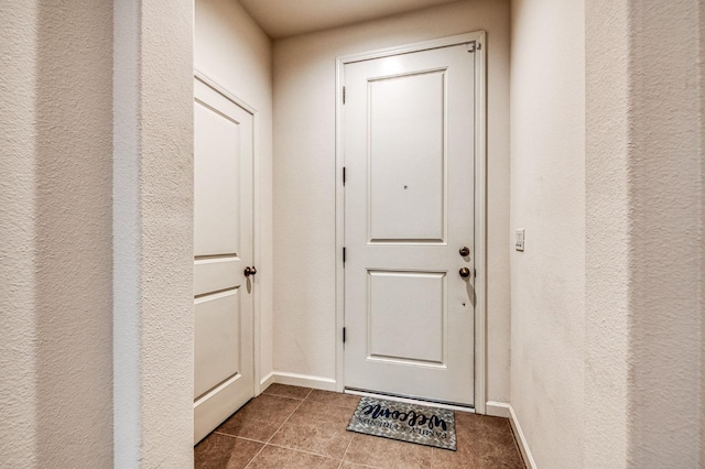 doorway to outside featuring tile patterned flooring