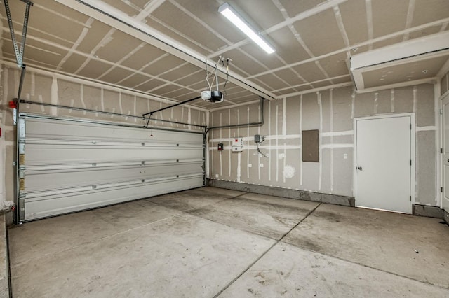 garage featuring electric panel and a garage door opener