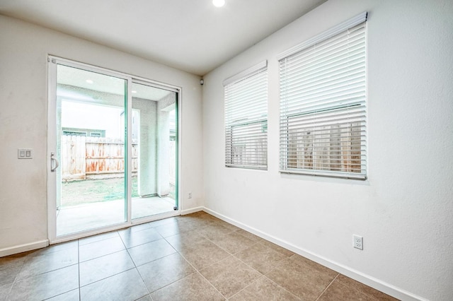 spare room featuring light tile patterned flooring