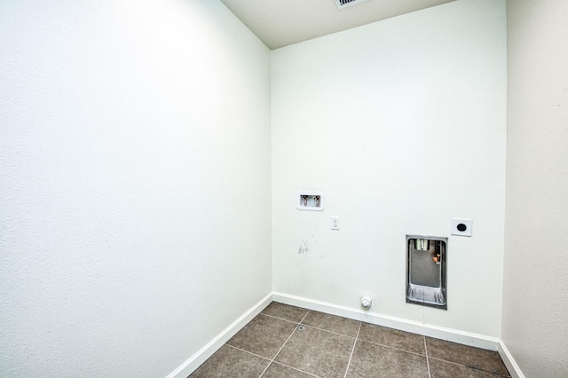 laundry area featuring washer hookup, electric dryer hookup, and dark tile patterned floors