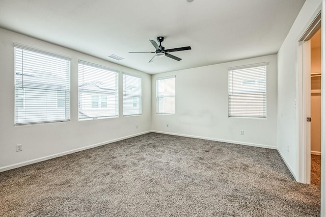 carpeted spare room featuring ceiling fan