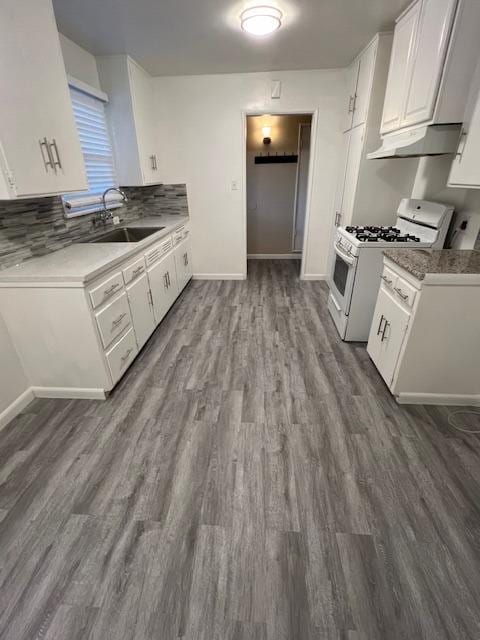 kitchen featuring sink, white cabinets, wood-type flooring, and white gas range oven