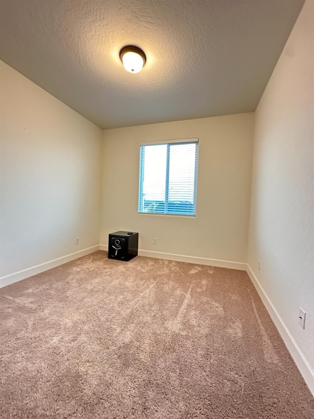 empty room featuring carpet floors and a textured ceiling