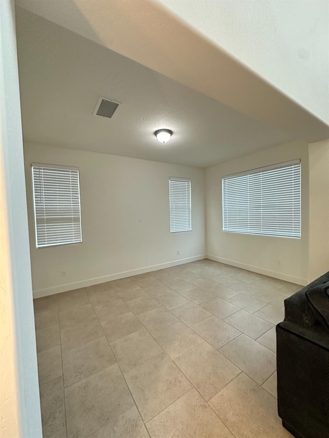 unfurnished room with light tile patterned floors