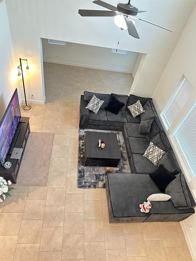 living room featuring ceiling fan and light tile patterned floors