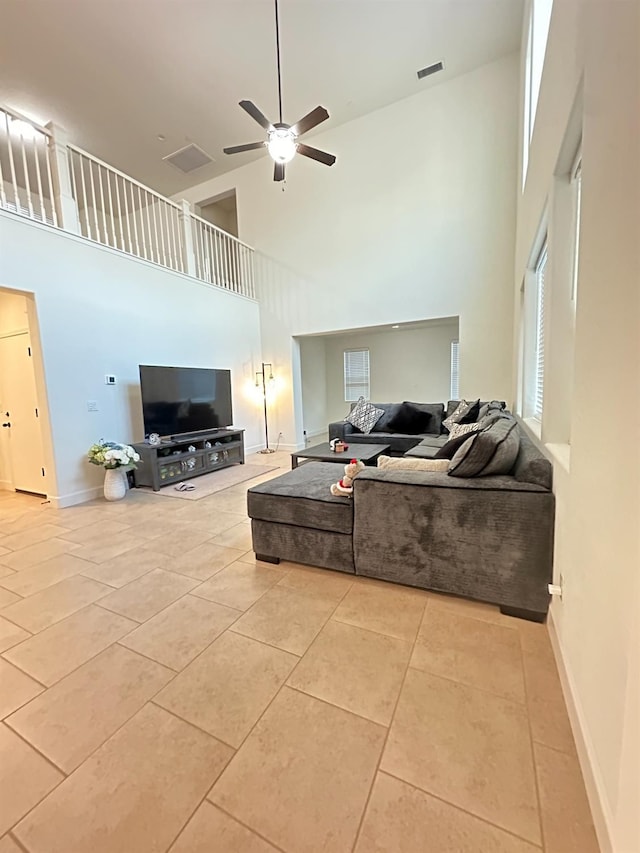 living room featuring high vaulted ceiling, ceiling fan, and light tile patterned flooring