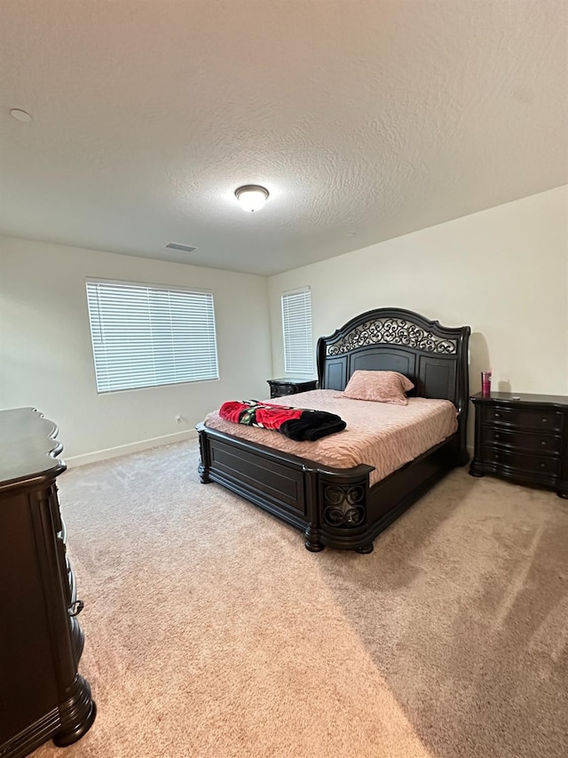 carpeted bedroom with a textured ceiling