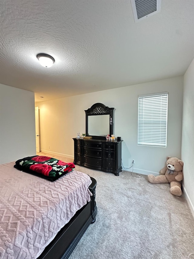 carpeted bedroom with a textured ceiling