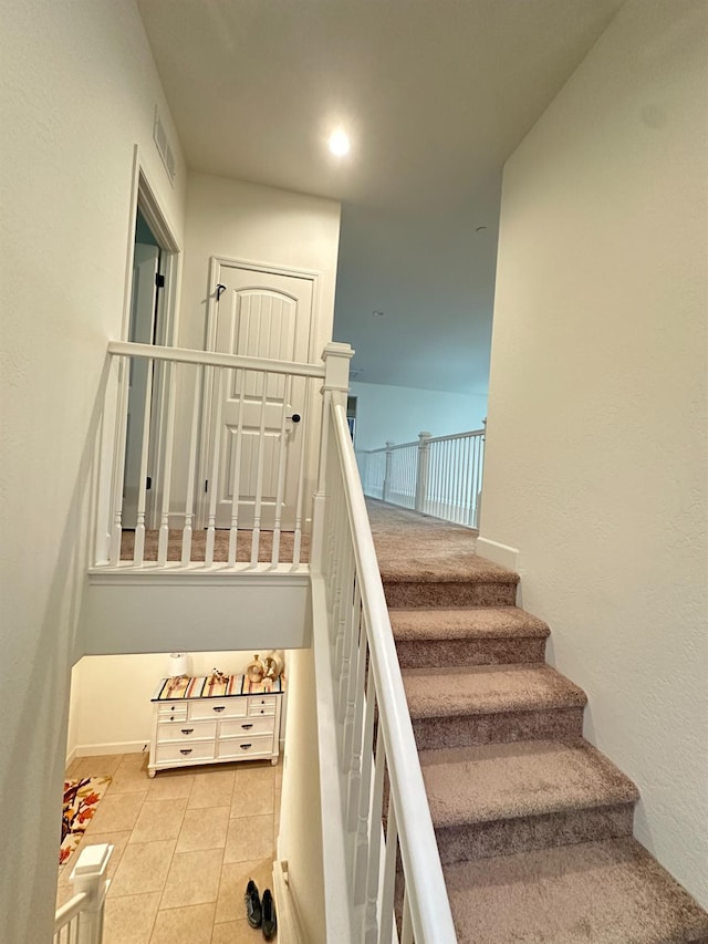 stairs featuring tile patterned flooring