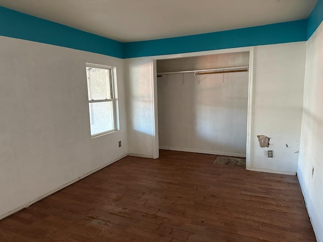 unfurnished bedroom featuring dark wood-type flooring