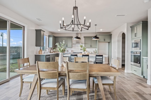 946 Talus Way S, Madera, CA 93636 - dining space with recessed lighting, arched walkways, a chandelier, and light wood finished floors