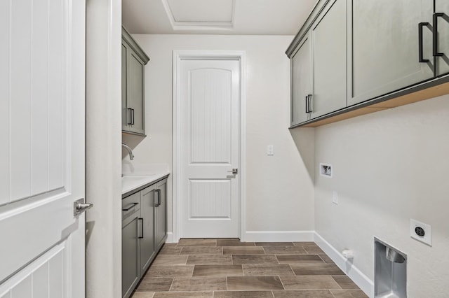 washroom featuring sink, cabinets, hookup for an electric dryer, gas dryer hookup, and hookup for a washing machine