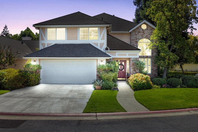 view of front of house featuring a yard and a garage