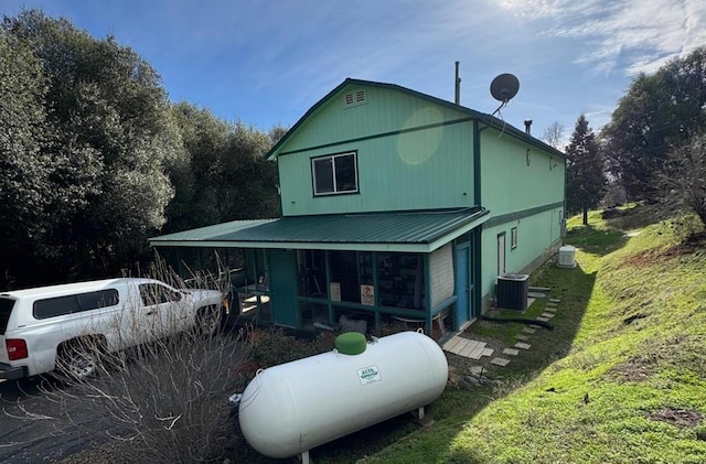 exterior space with a lawn and cooling unit