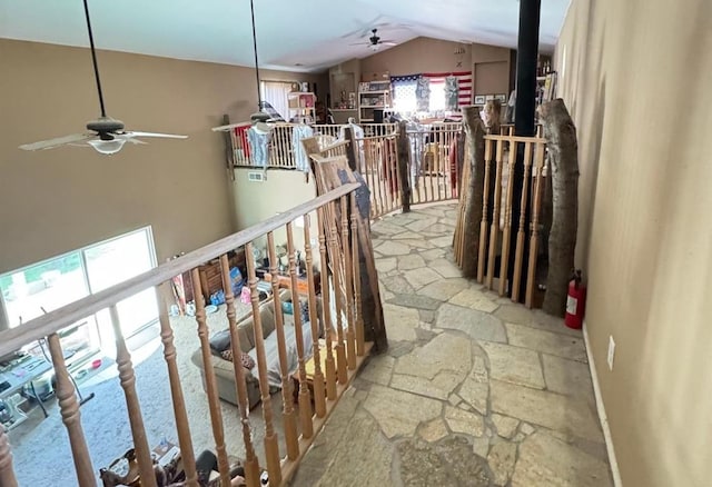 hall featuring lofted ceiling