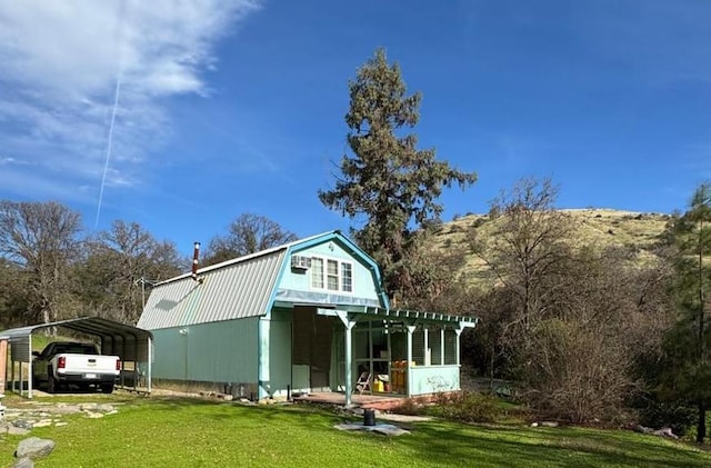 view of property exterior with a carport and a lawn