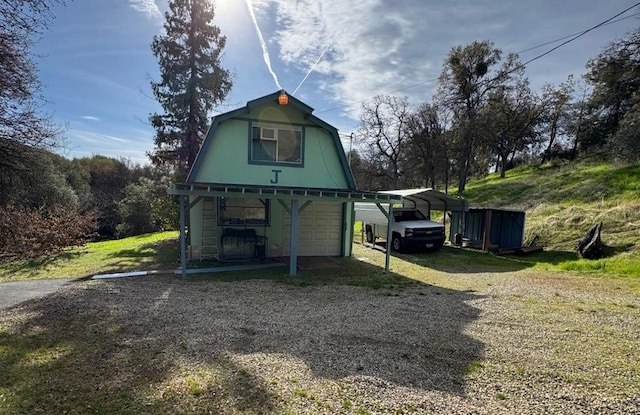 view of outdoor structure featuring a yard and a carport