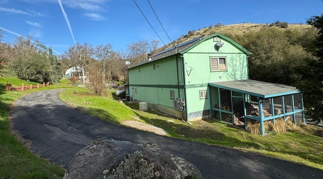 view of side of home featuring a yard