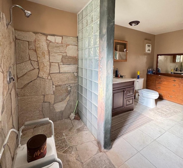 bathroom with vanity, toilet, and walk in shower