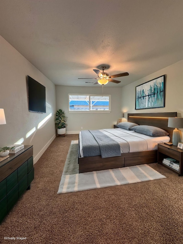 carpeted bedroom with a textured ceiling and ceiling fan