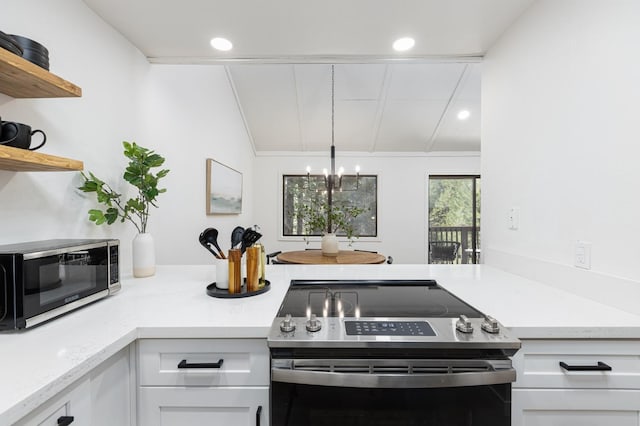 kitchen featuring a notable chandelier, white cabinetry, appliances with stainless steel finishes, and lofted ceiling