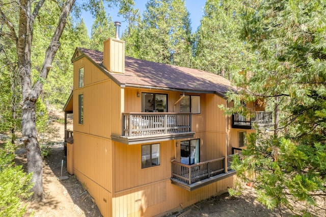 rear view of property with a balcony