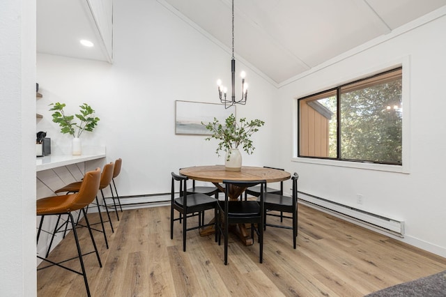 dining area with a chandelier, light wood-type flooring, baseboard heating, and lofted ceiling