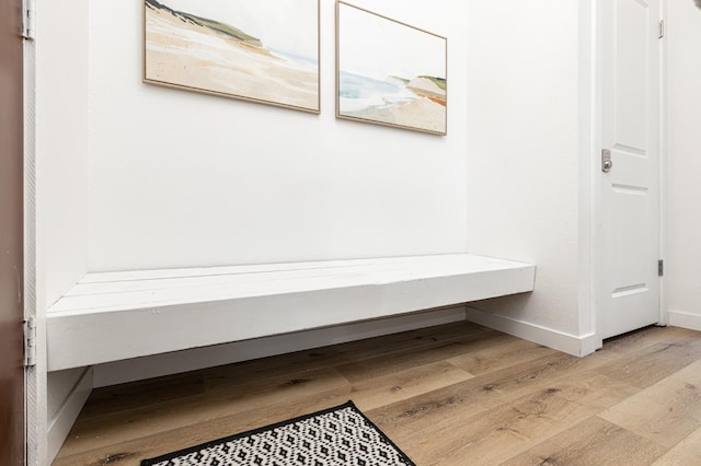 corridor with light hardwood / wood-style flooring