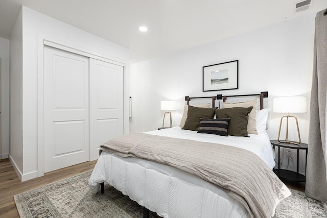 bedroom featuring hardwood / wood-style flooring and a closet