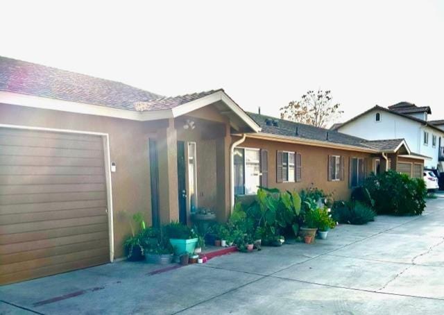 rear view of property with a garage