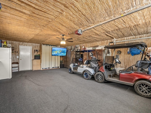 28899 Limestone Way, Coarsegold, CA 93614 - garage featuring wooden walls, a garage door opener, and a ceiling fan