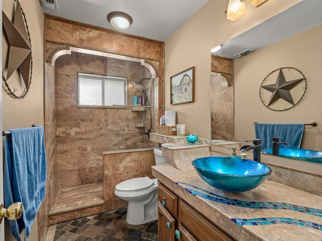 28899 Limestone Way, Coarsegold, CA 93614 - bathroom with a tile shower, toilet, vanity, and stone finish flooring