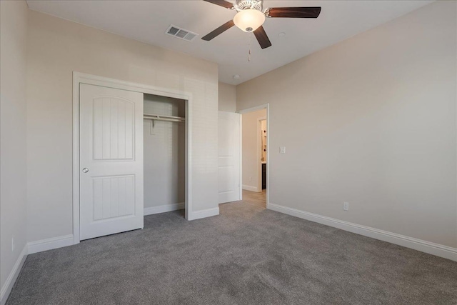 unfurnished bedroom with carpet flooring, ceiling fan, and a closet