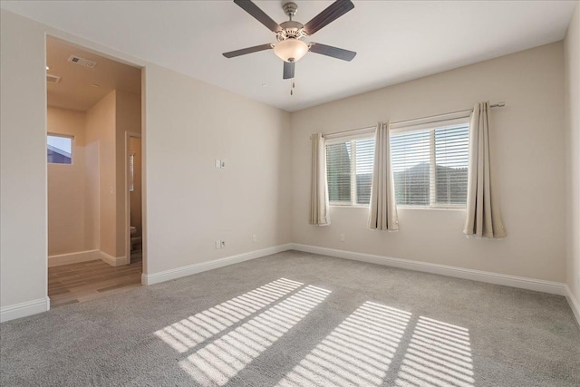 spare room with light carpet and ceiling fan