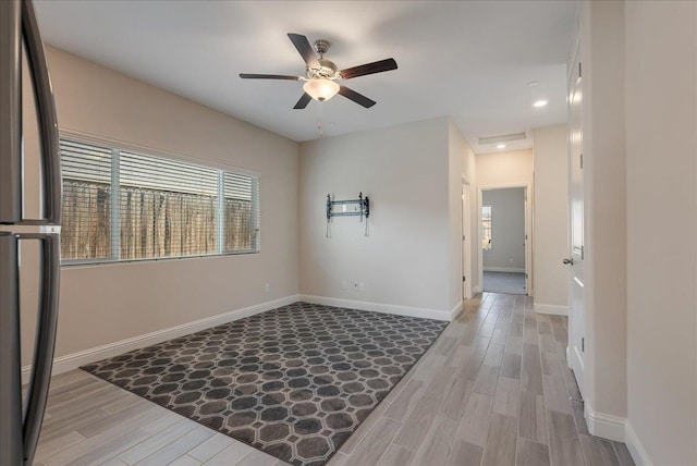 spare room featuring light wood-type flooring and ceiling fan