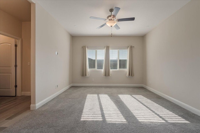 carpeted spare room with ceiling fan