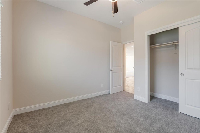 unfurnished bedroom with a closet, ceiling fan, and light colored carpet