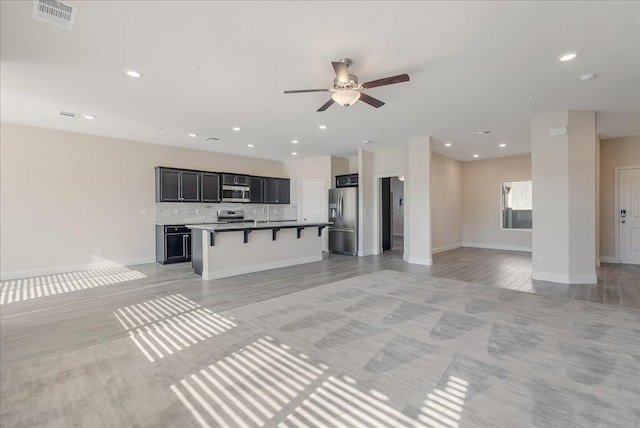 unfurnished living room featuring ceiling fan