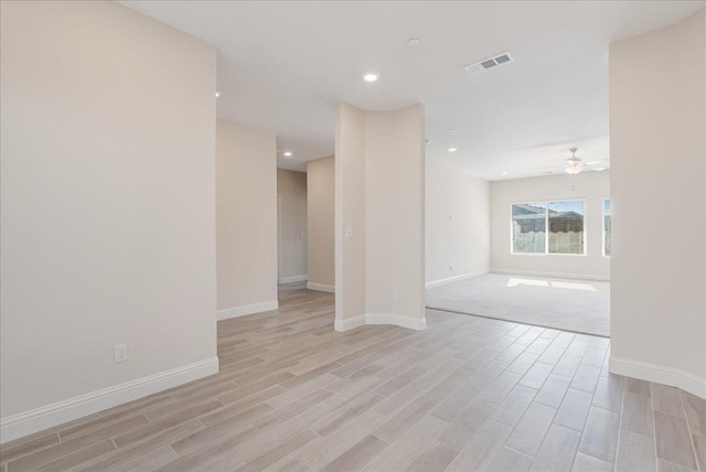 unfurnished room featuring ceiling fan and light wood-type flooring