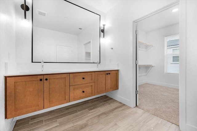 bathroom with vanity and hardwood / wood-style flooring