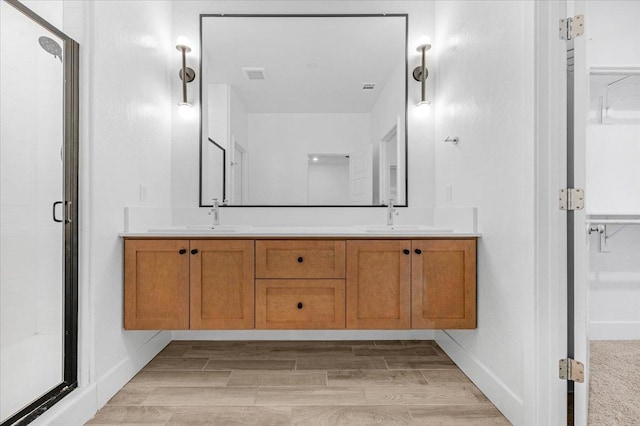 bathroom with an enclosed shower and vanity