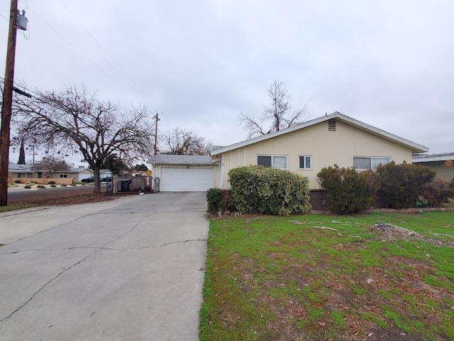 ranch-style house with a front yard and a garage