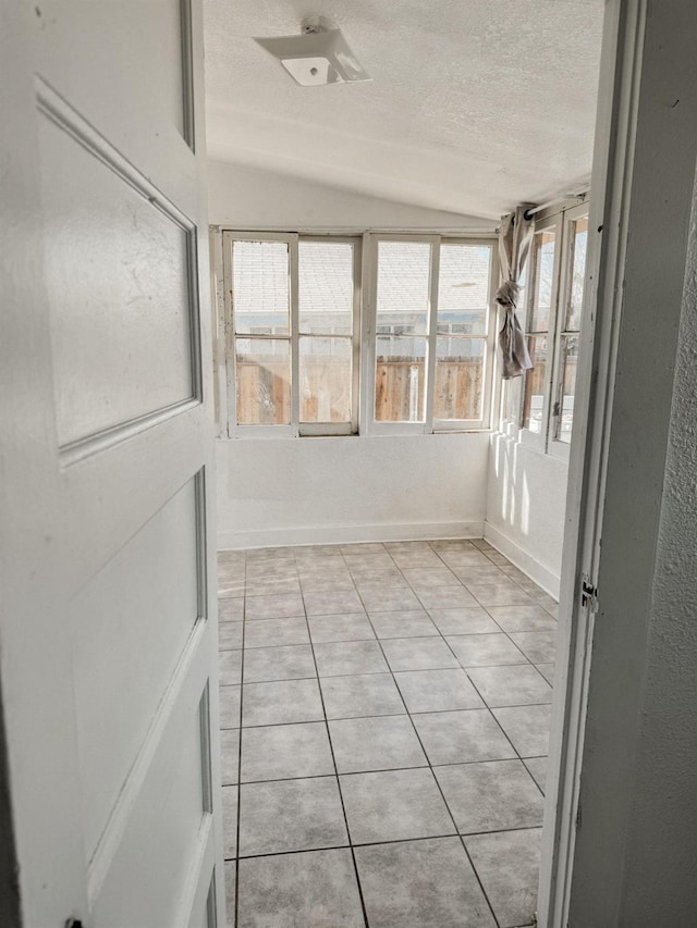 unfurnished sunroom with vaulted ceiling