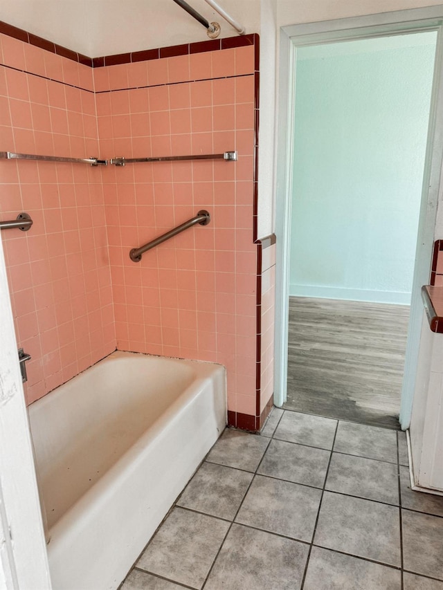 bathroom with tile patterned flooring and shower / bathtub combination