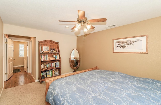 bedroom featuring carpet flooring, ceiling fan, and ensuite bathroom