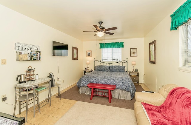 tiled bedroom featuring ceiling fan