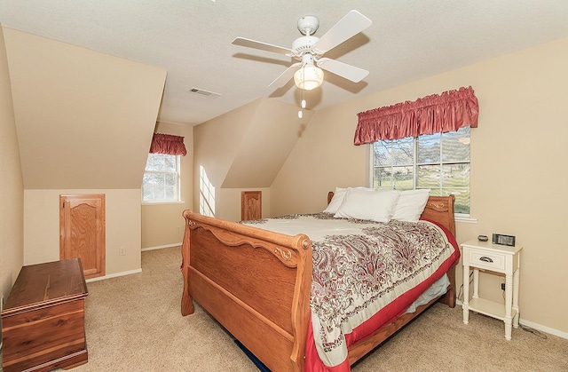 carpeted bedroom with multiple windows, vaulted ceiling, and ceiling fan