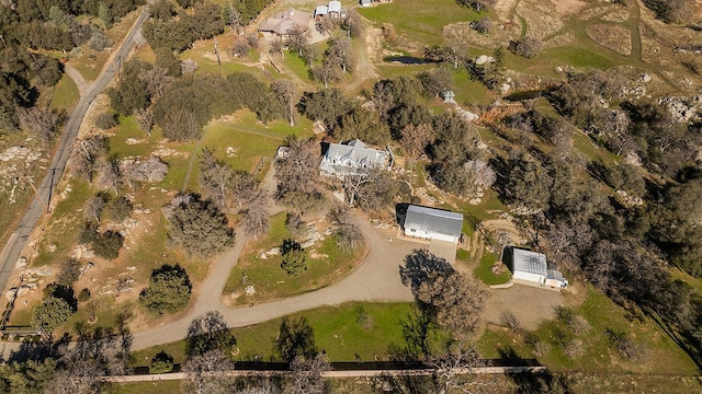 birds eye view of property with a rural view